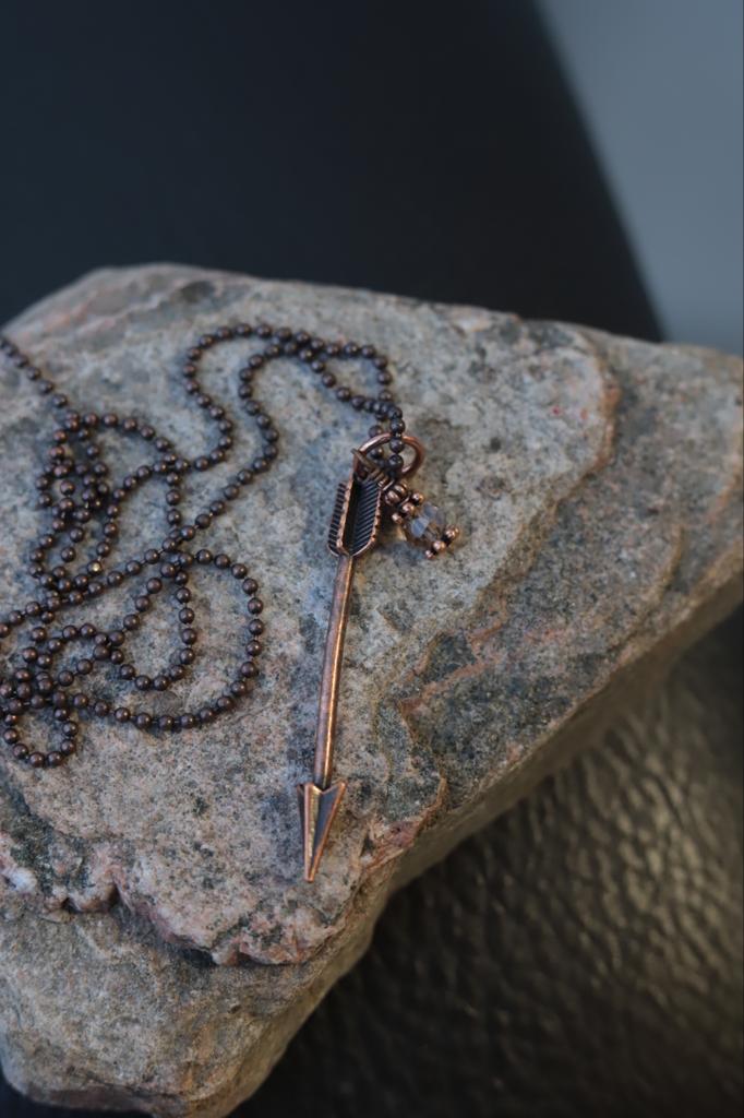 Antiqued copper ball necklace with arrow charm and bead charm