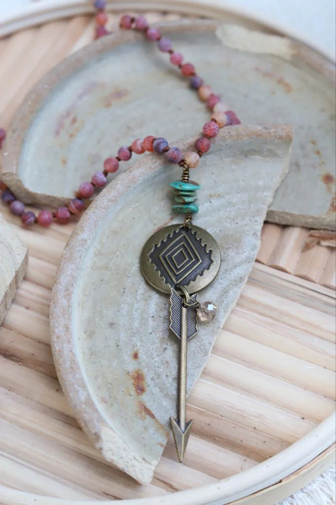 Burgundy pink bead necklace with antiqued gold arrow and turquoise